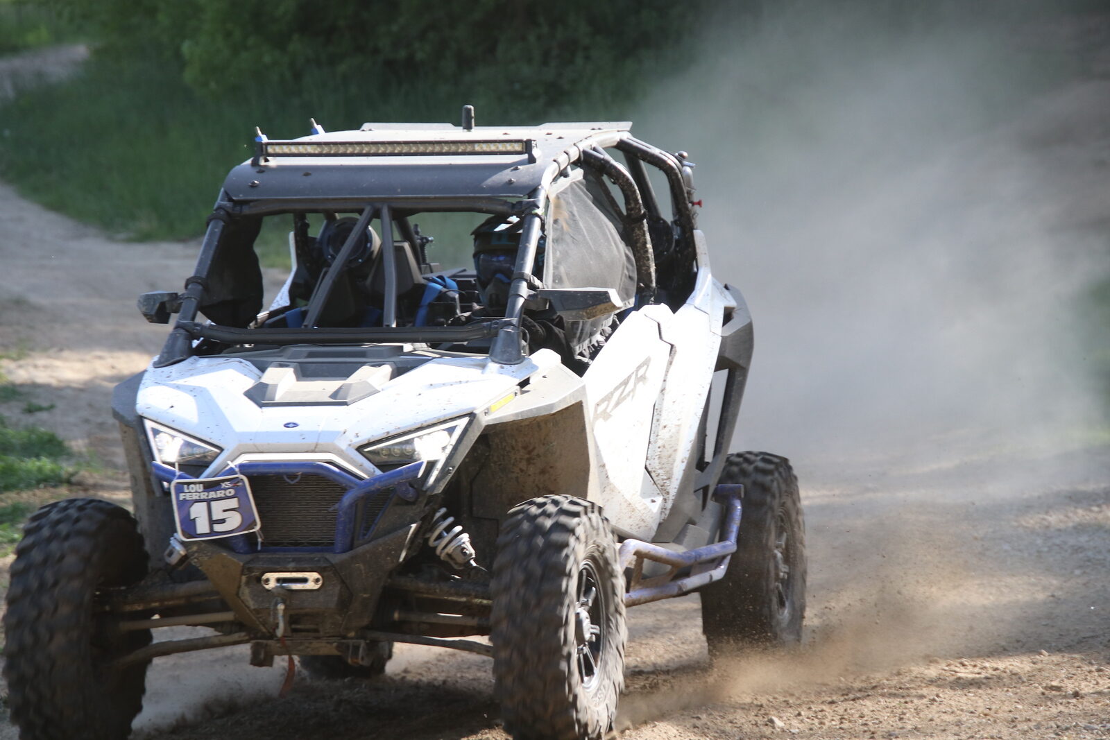 Lou's Pro XP #15 racing head-on through dust