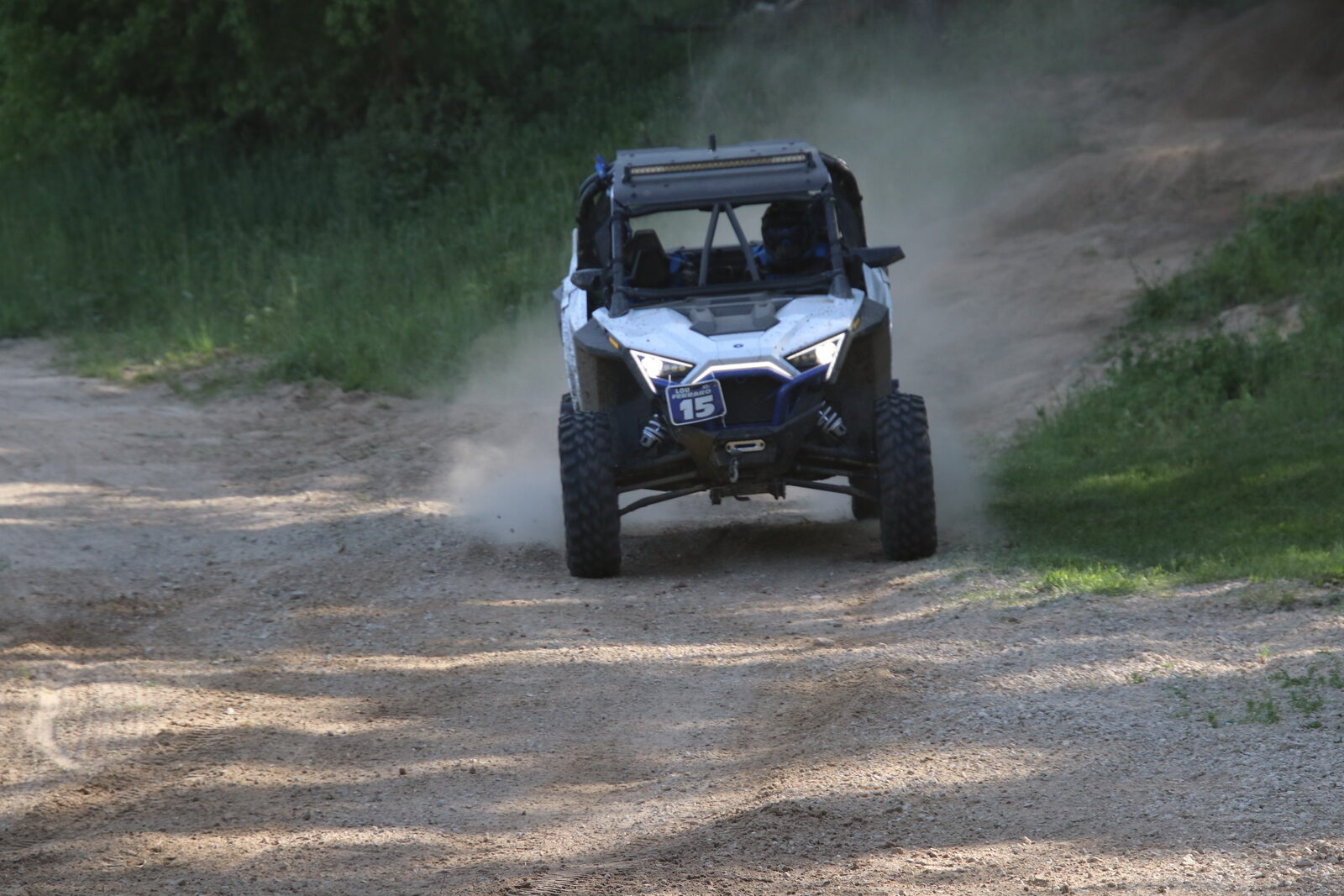 Lou's Pro XP #15 racing head-on through dust