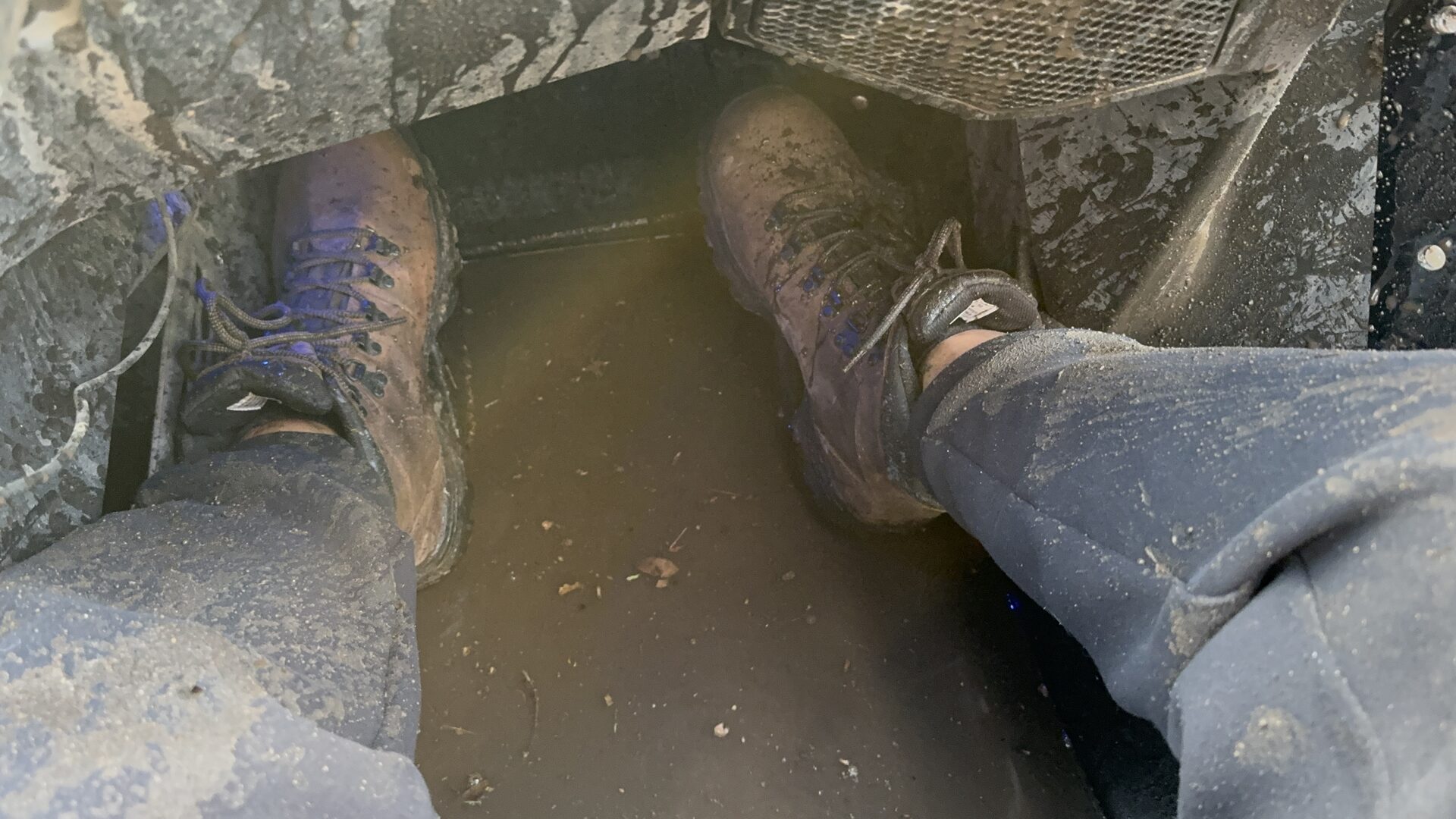 Muddy boots in the footwell of the UTV